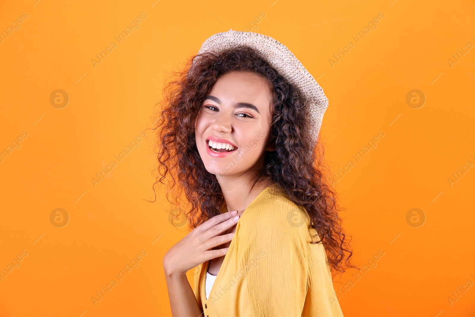 Photo of Portrait of laughing African-American woman on color background