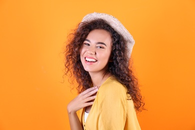 Photo of Portrait of laughing African-American woman on color background