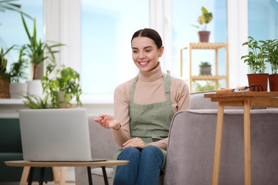 Photo of Teacher conducting online gardening course at home. Time for hobby