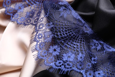 Beautiful blue lace on color fabrics, closeup