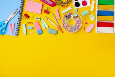 Flat lay composition with different school stationery on yellow background, space for text. Back to school