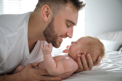 Father with his newborn son at home