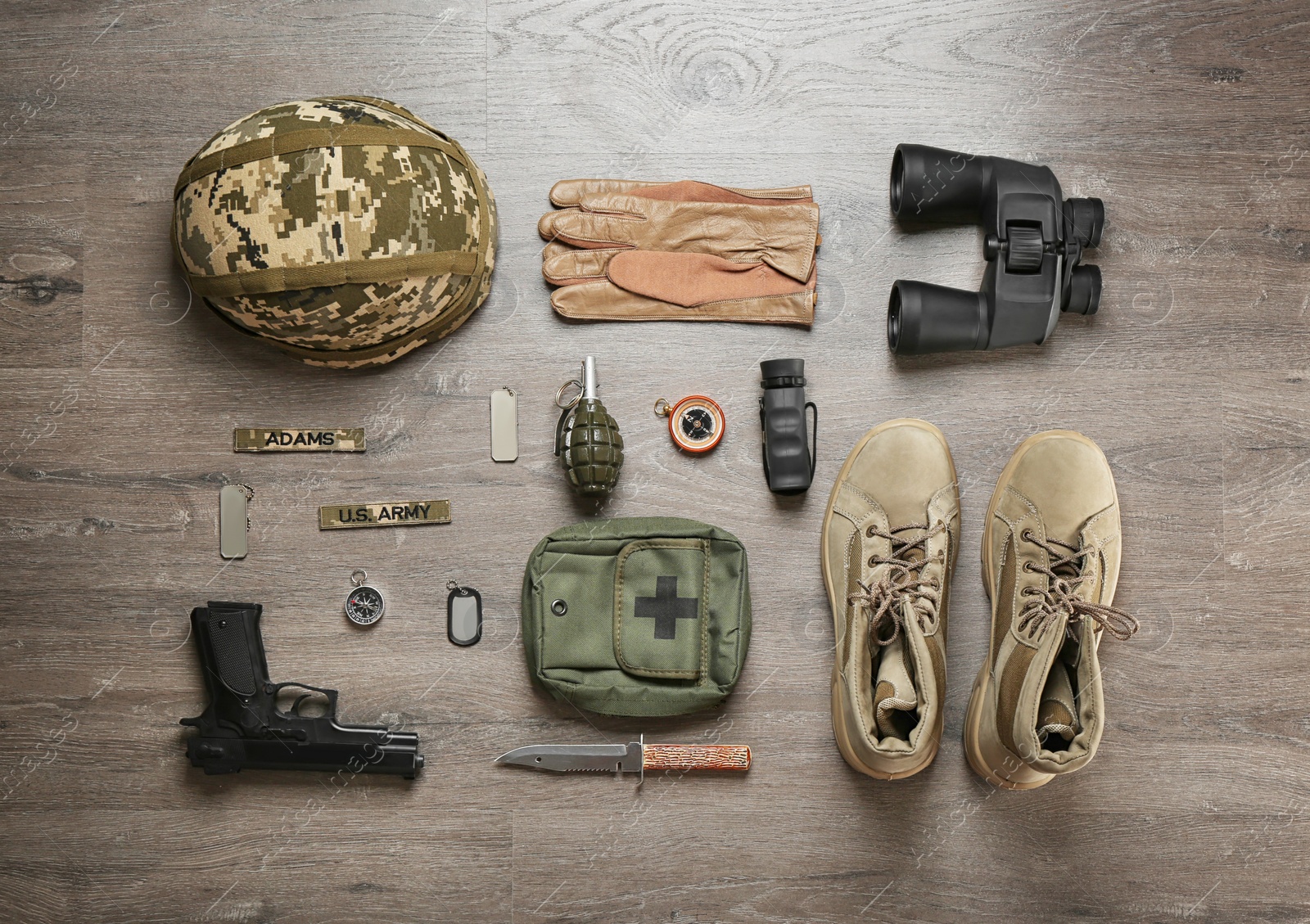 Photo of Set of military equipment and combat boots on wooden background, flat lay