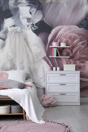 Teenage girl's room interior with comfortable bed and floral wallpaper. Idea for stylish design