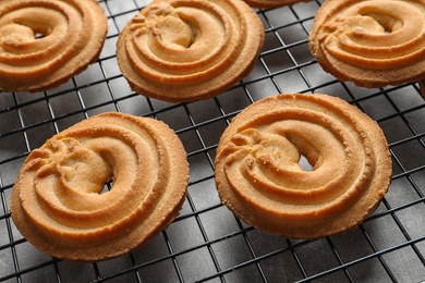 Photo of Baking grid with Danish butter cookies on table, closeup