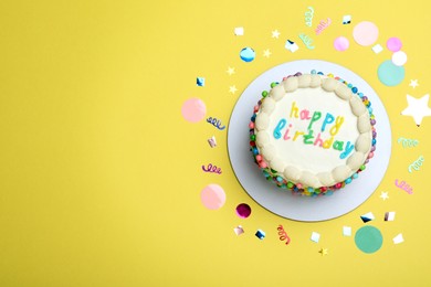 Photo of Cute bento cake with tasty cream and confetti on yellow background, flat lay. Space for text