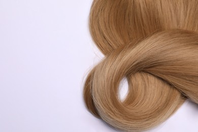 Photo of Beautiful dark blonde straight hair on white background, top view