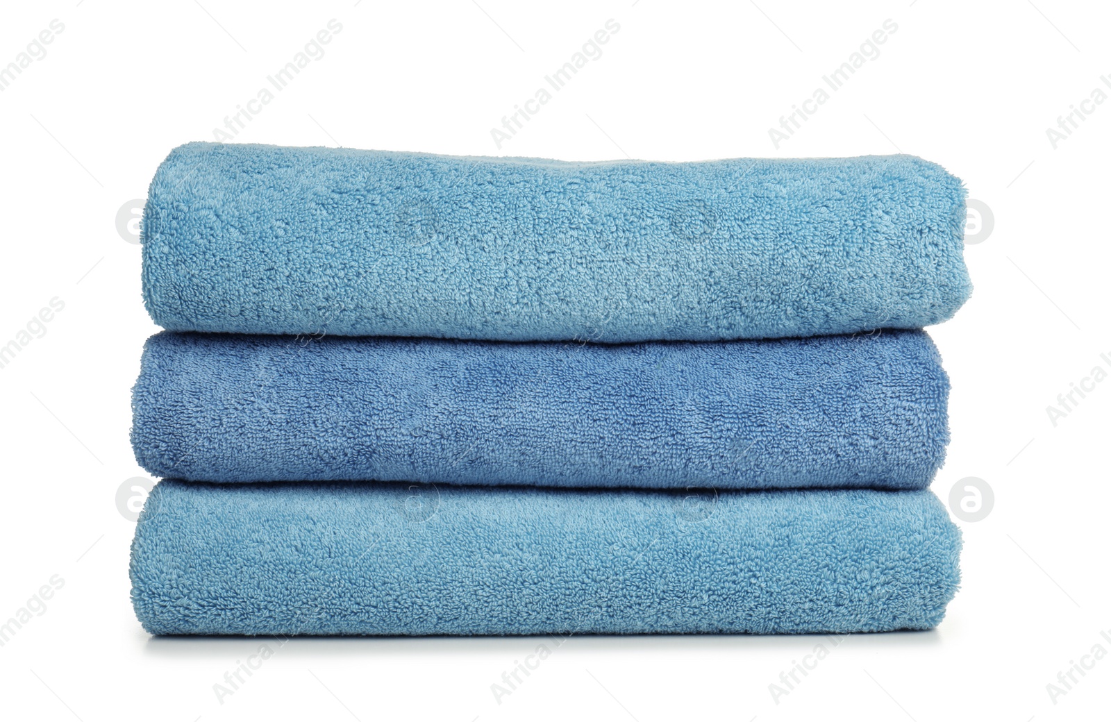 Photo of Folded soft terry towels on white background