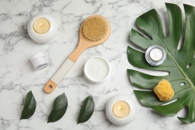 Flat lay composition with different body care products on marble background