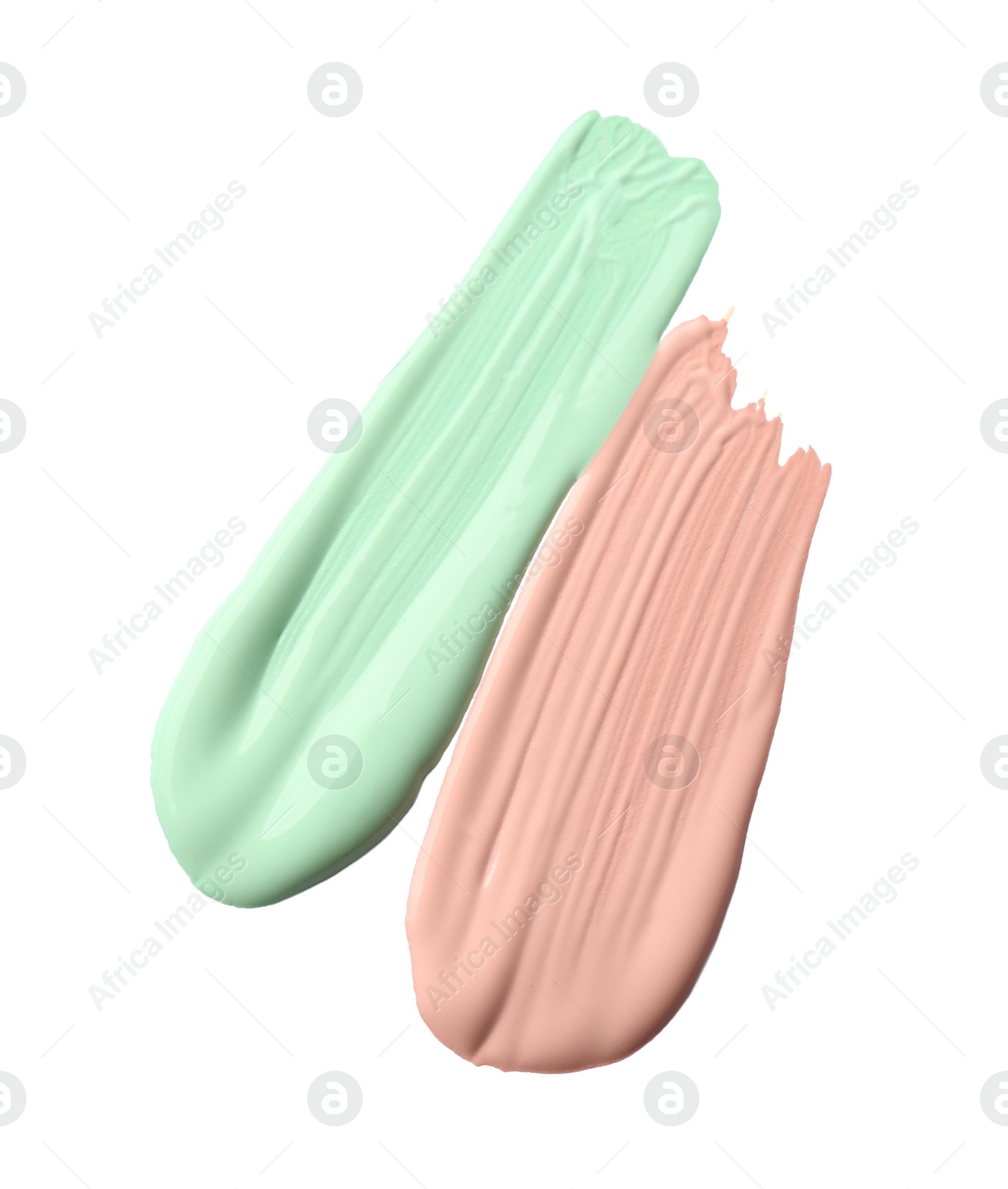 Photo of Strokes of different color correcting concealers isolated on white