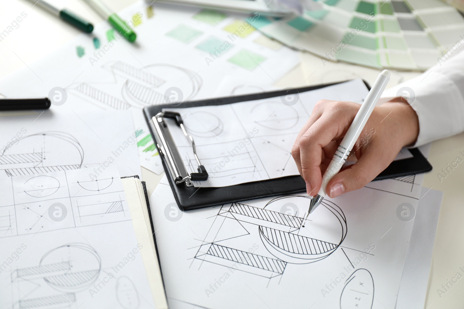 Photo of Female designer working at wooden table, closeup