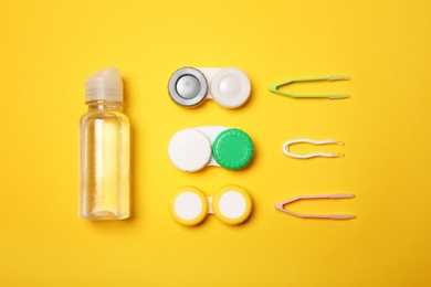 Photo of Flat lay composition with contact lens accessories on color background