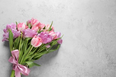 Photo of Beautiful bouquet of colorful tulip flowers on light gray table, top view. Space for text