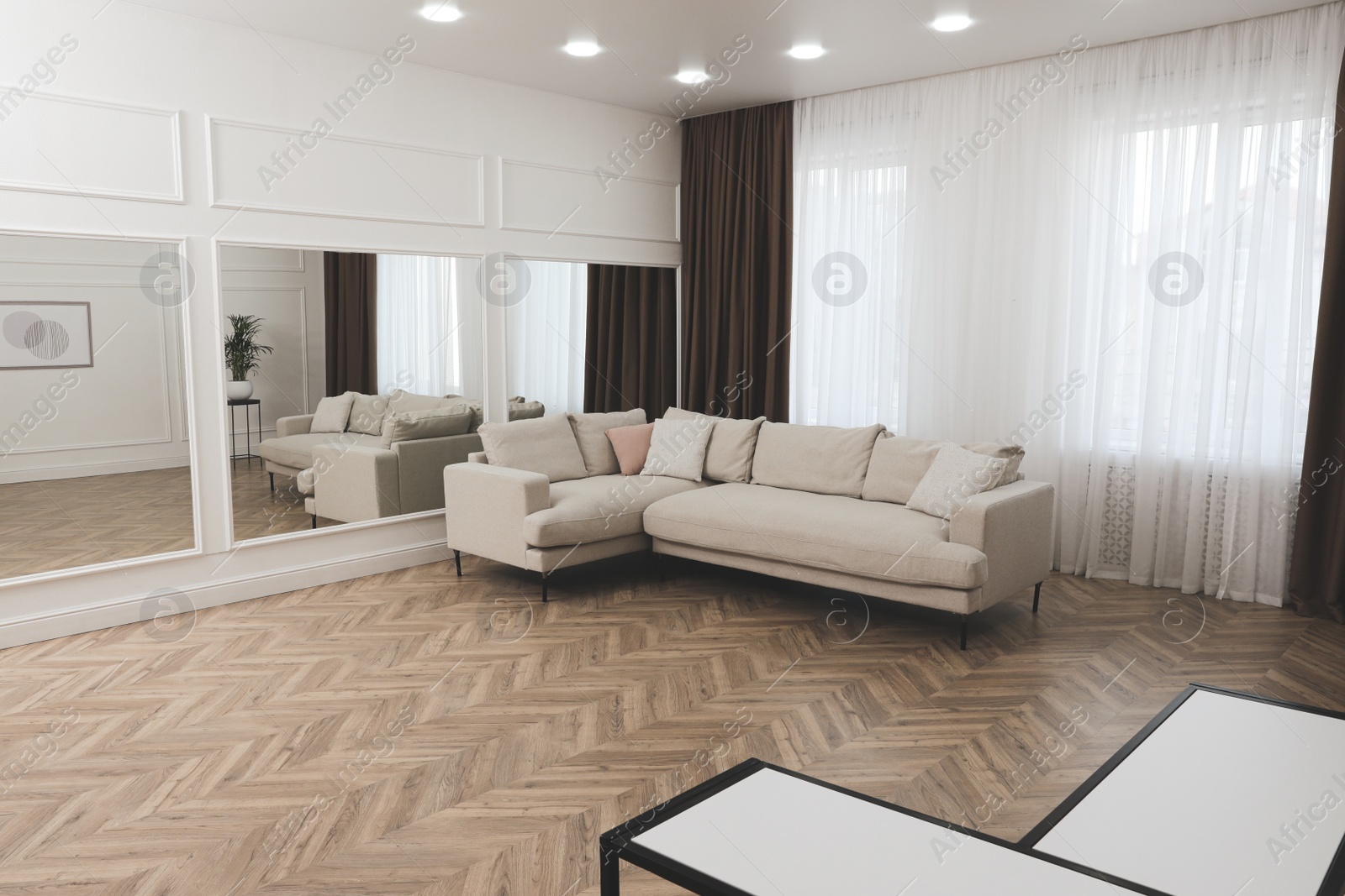 Photo of Modern living room with parquet flooring and stylish furniture