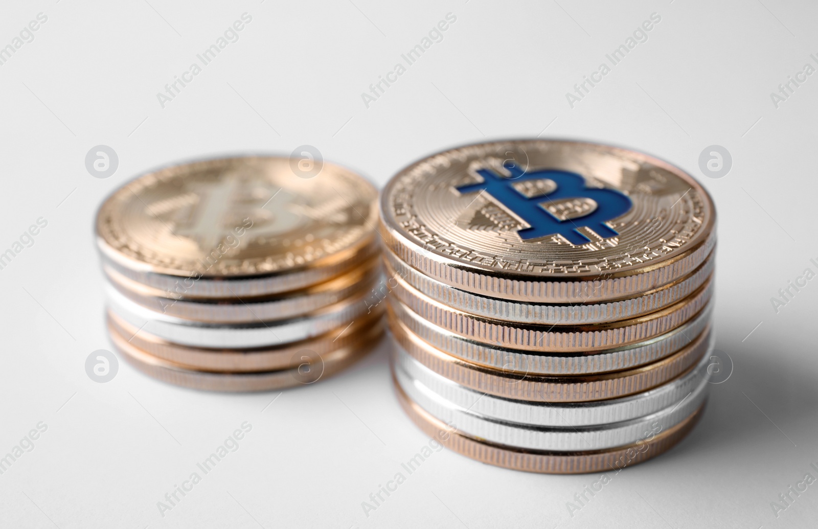 Photo of Stacks of bitcoins on white background. Digital currency