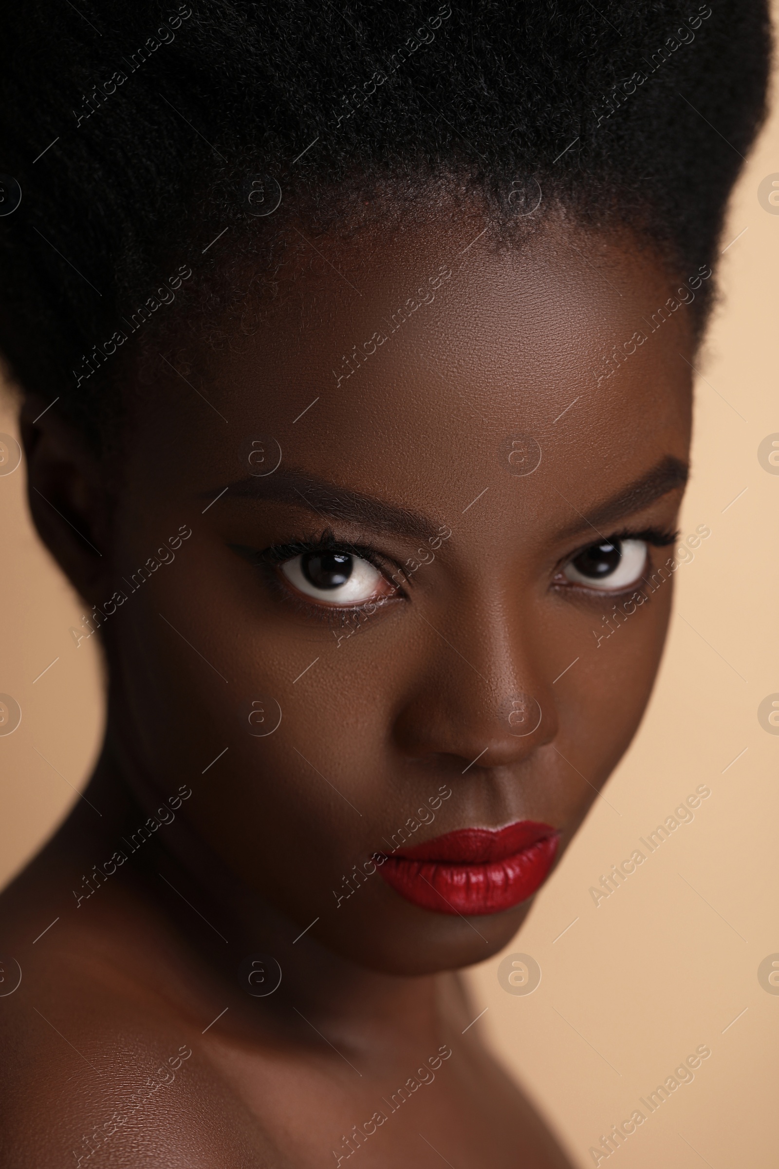 Photo of Portrait of beautiful woman on beige background, closeup