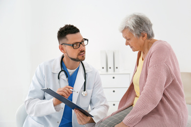 Doctor with senior patient in modern office