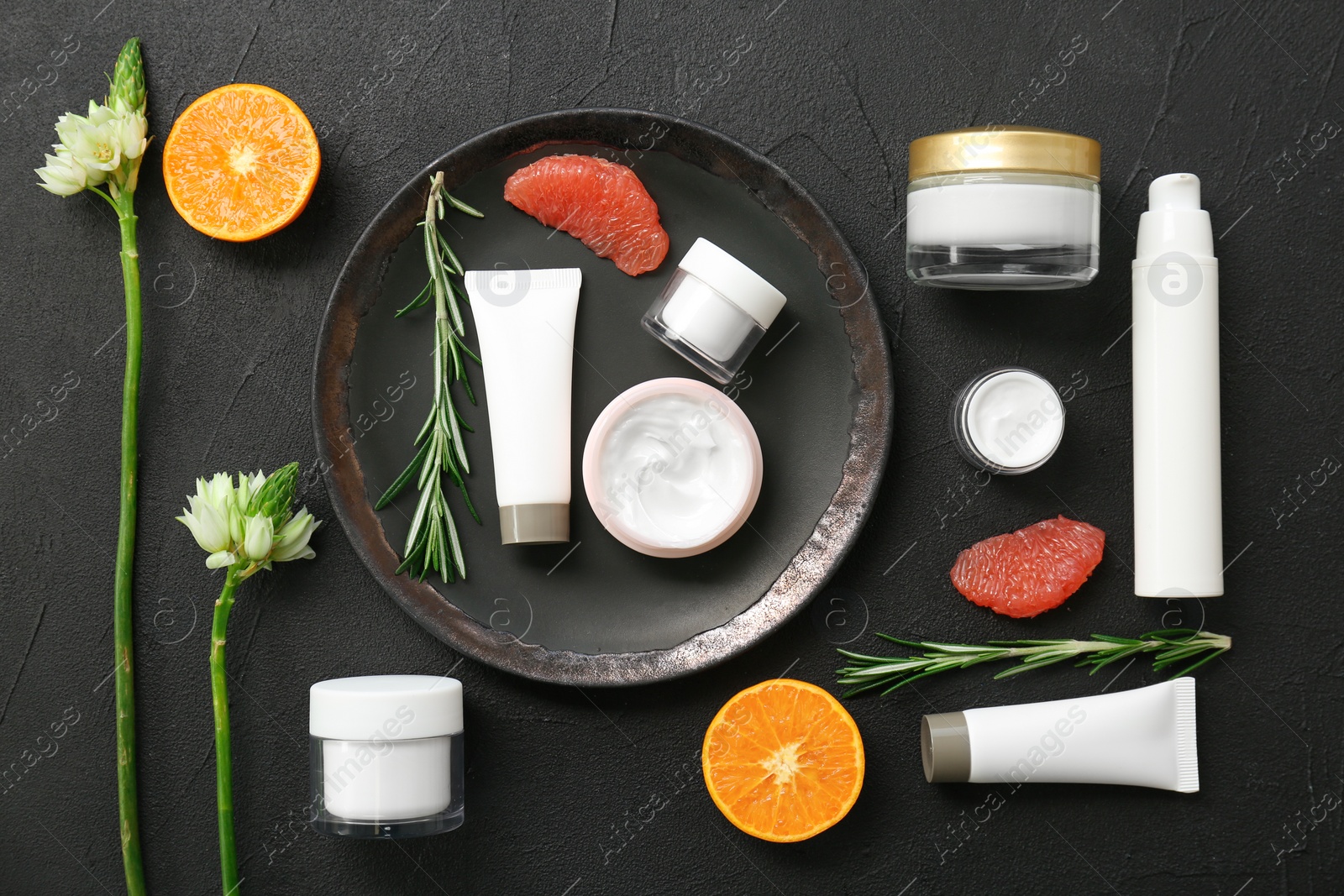 Photo of Beautiful composition with cosmetics on dark background, flat lay