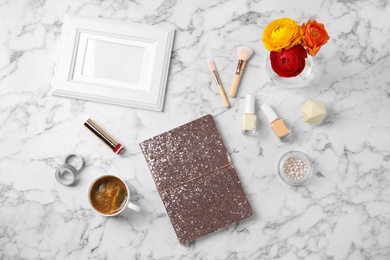 Photo of Flat lay composition with notebook, coffee and cosmetics on marble table