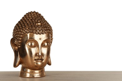 Photo of Beautiful golden Buddha sculpture on wooden table against grey background. Space for text