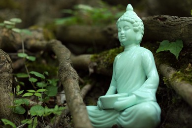 Photo of Decorative Buddha statue near tree outdoors. Space for text