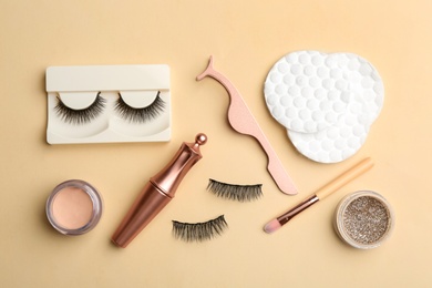 Flat lay composition with magnetic eyelashes and accessories on beige background