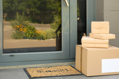 Photo of Cardboard boxes near door. Parcel delivery service