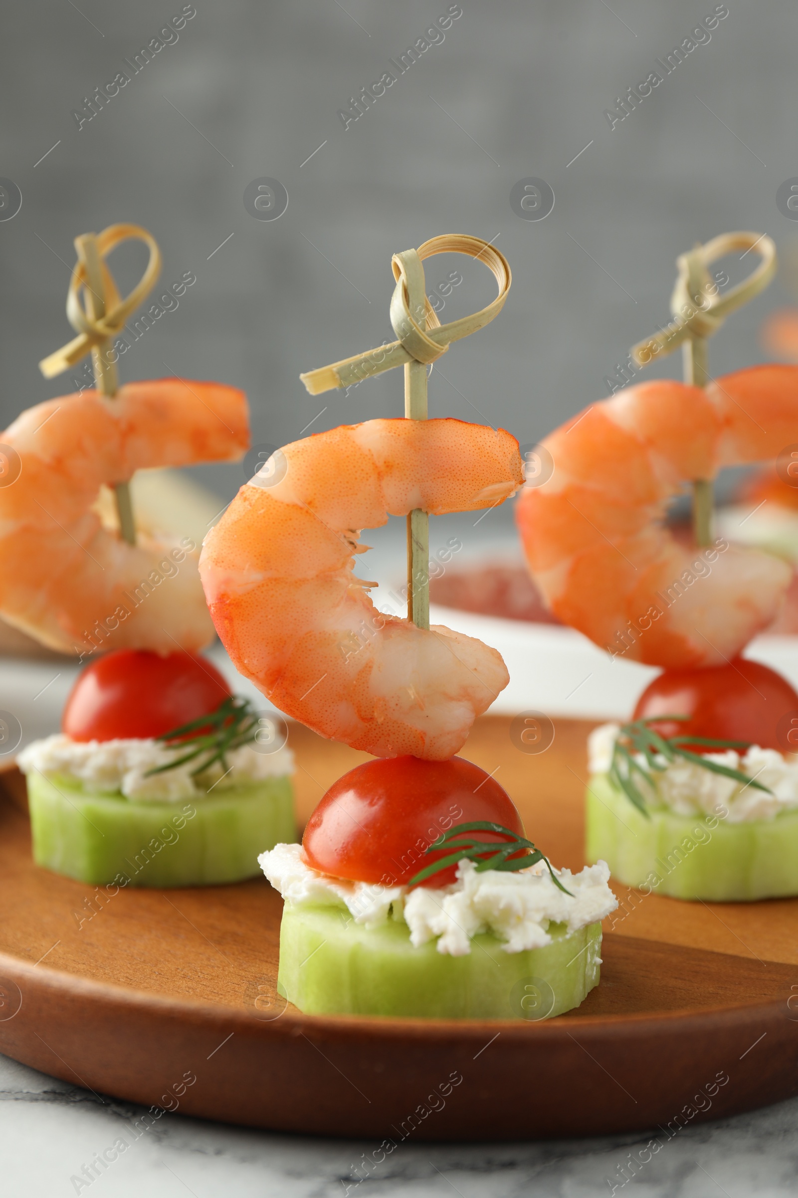 Photo of Tasty canapes with shrimps, vegetables and cream cheese on white table, closeup