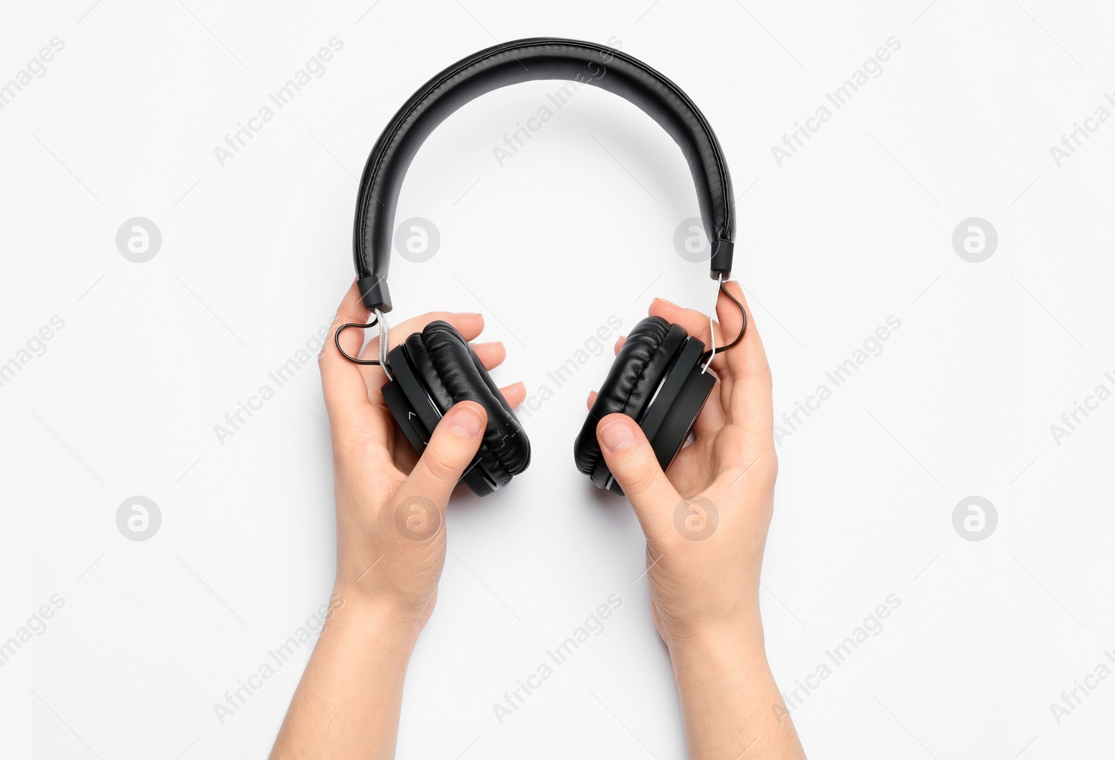 Photo of Woman holding stylish headphones on white background, closeup