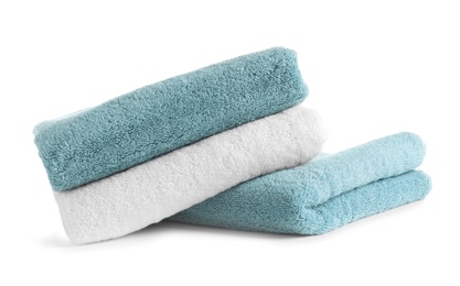 Photo of Stack of clean soft towels on white background