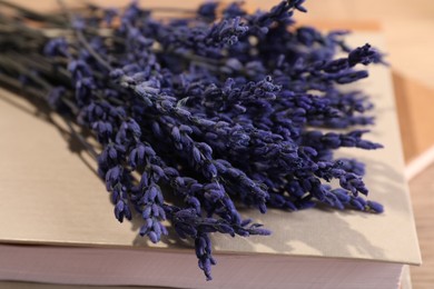 Photo of Bouquet of beautiful preserved lavender flowers and notebooks on table, closeup