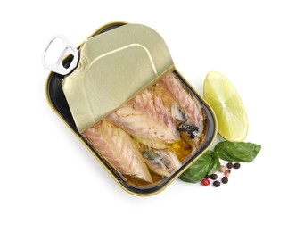 Open tin can with mackerel fillets, lime, peppercorns and basil on white background, top view