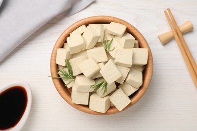 Photo of Delicious tofu with rosemary served on white wooden table, flat lay