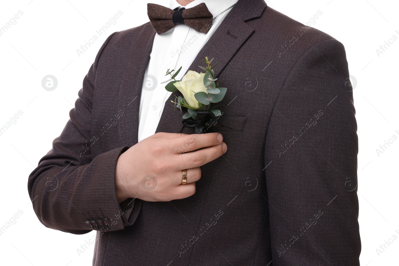 Photo of Groom with boutonniere on white background, closeup. Wedding accessory
