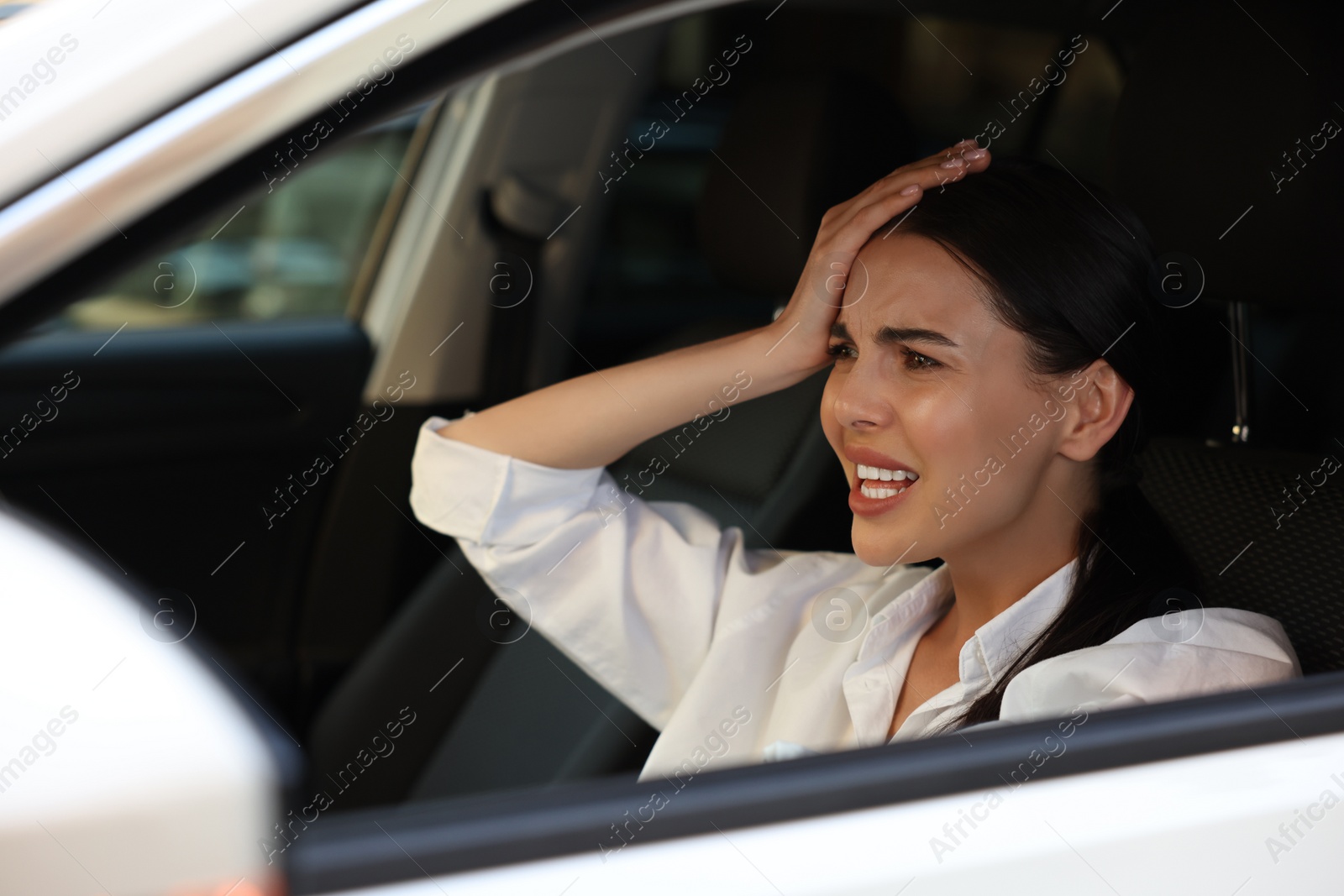 Photo of Stuck in traffic jam. Stressed driver in her car, view from outside