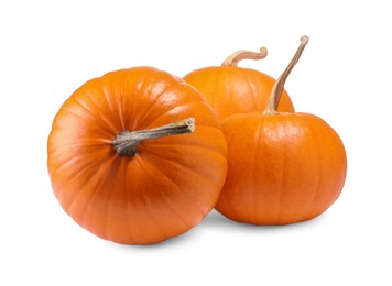 Photo of Many fresh orange pumpkins isolated on white