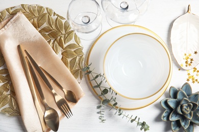 Elegant table setting on light background, top view