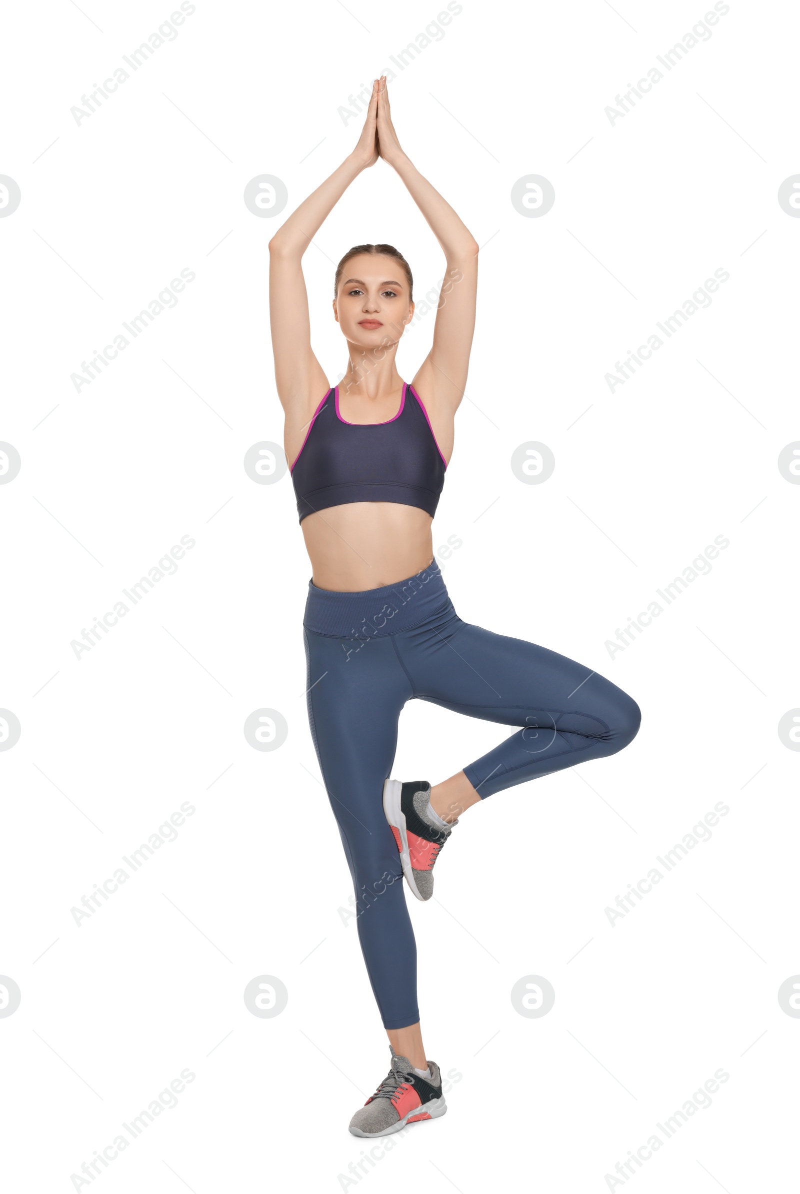 Photo of Young woman practicing yoga on white background