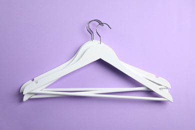 Photo of Flat lay composition with empty hangers on color background