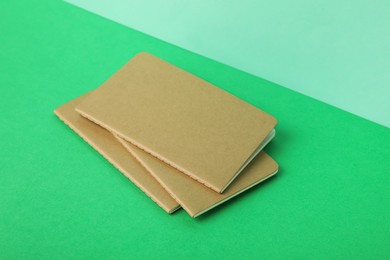 Photo of New stylish kraft planners on color background