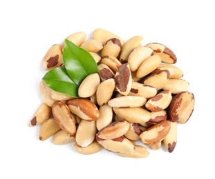 Photo of Brazil nuts with green leaves on white background, top view