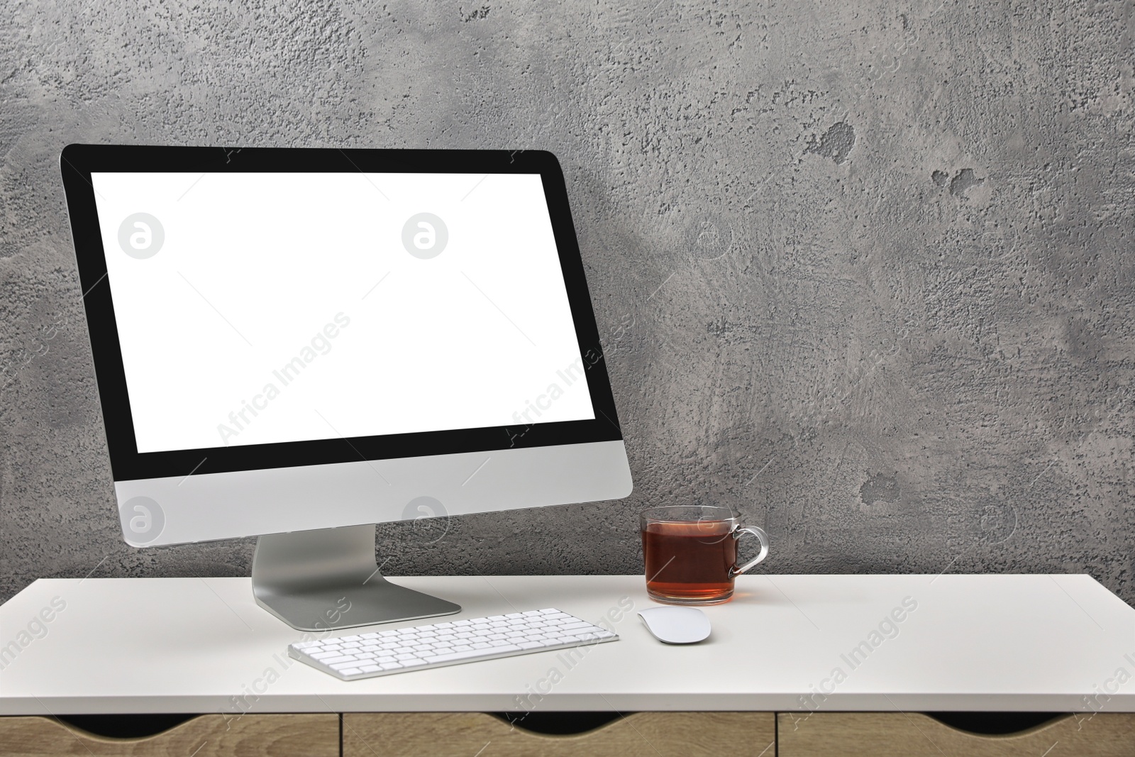 Photo of Workplace with modern computer monitor, keyboard and mouse on table. Mockup for design