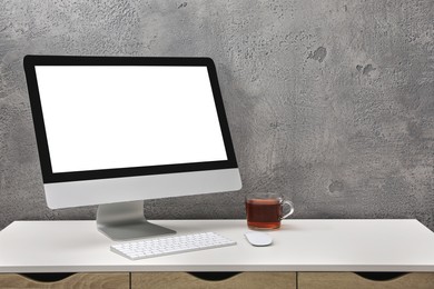 Workplace with modern computer monitor, keyboard and mouse on table. Mockup for design