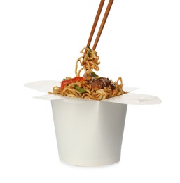 Photo of Box of wok noodles with vegetables, meat and chopsticks isolated on white