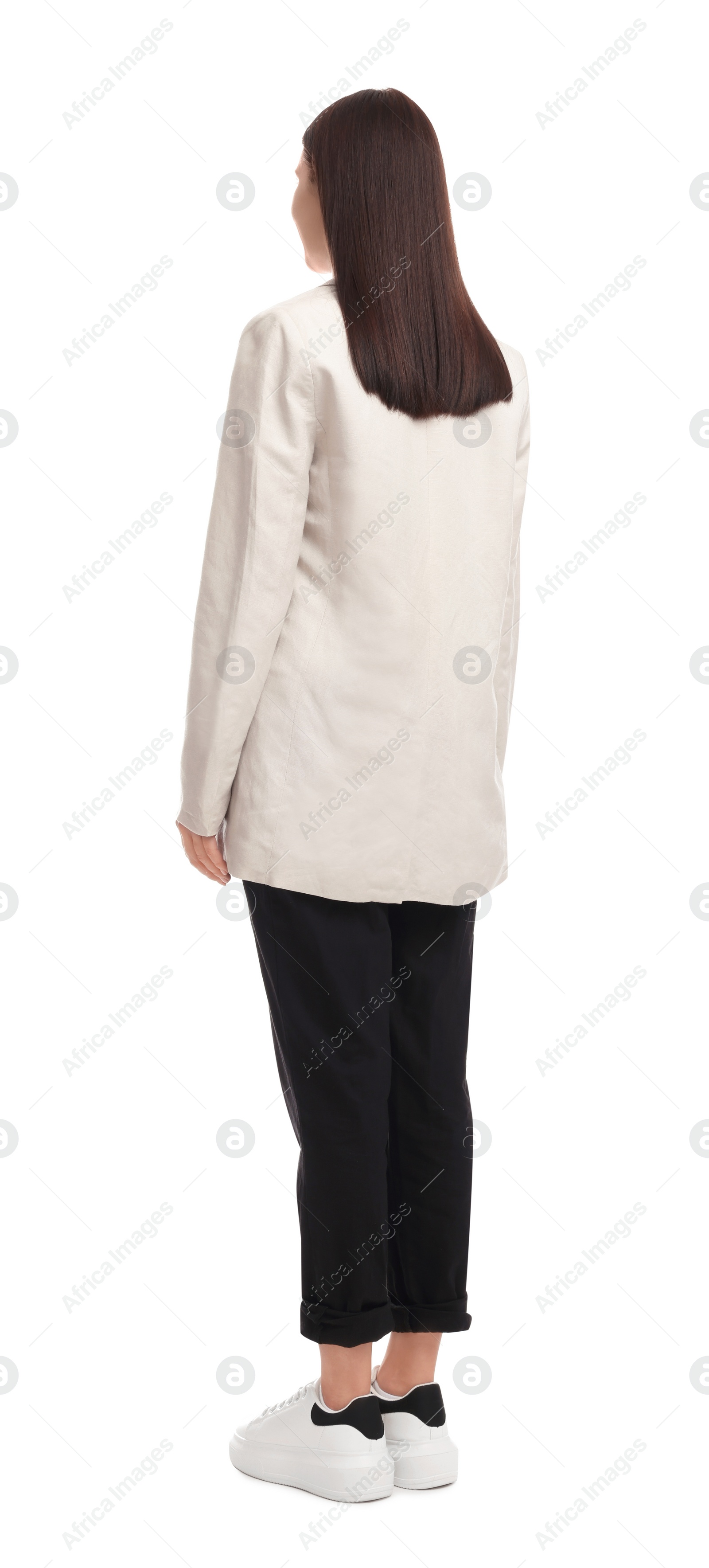 Photo of Young businesswoman in suit standing on white background