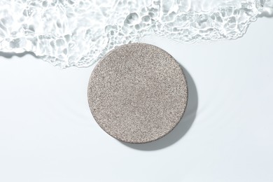 Photo of Presentation for product. Stone podium in water on white background, top view