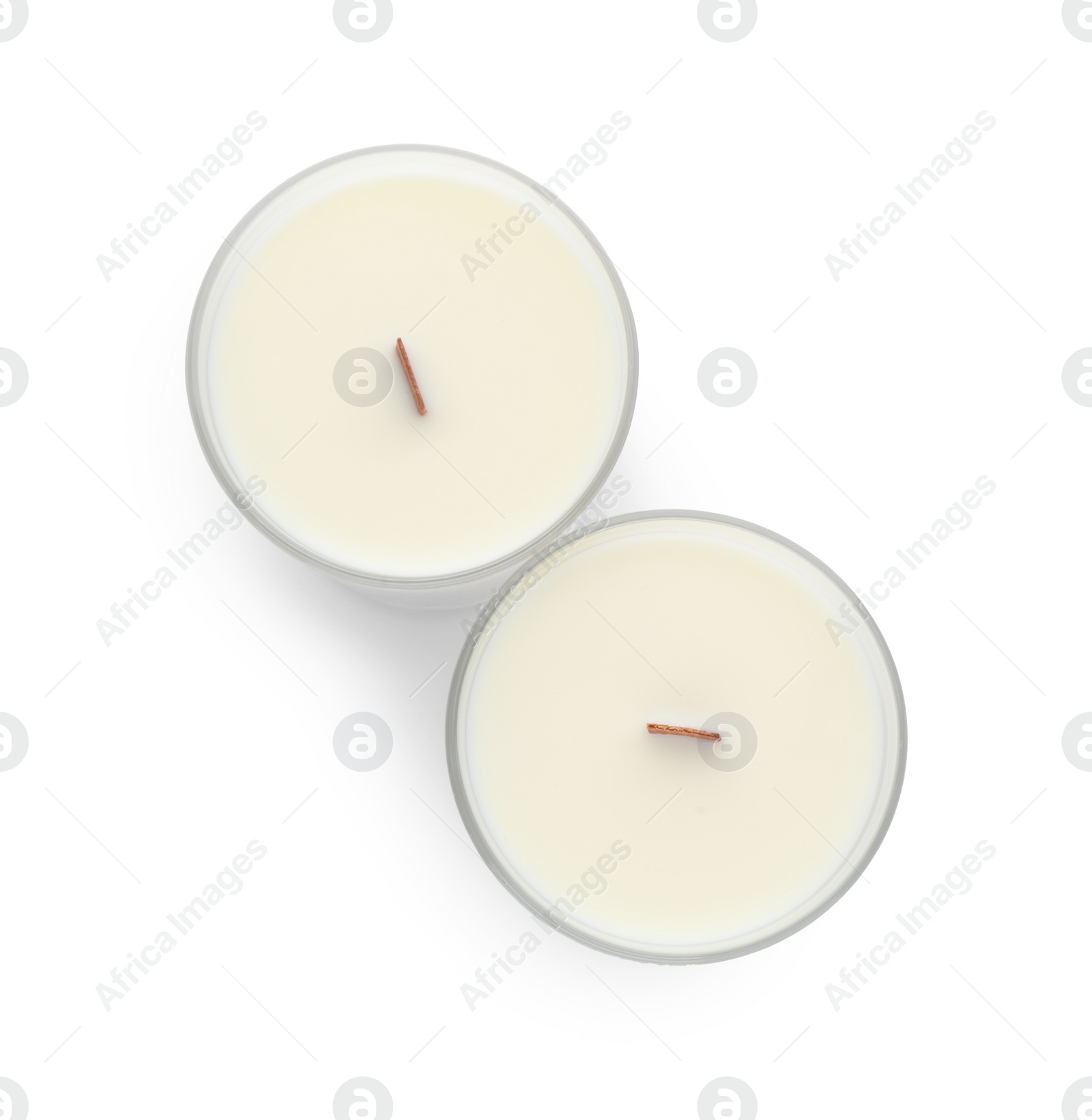 Photo of Aromatic soy candles with wooden wicks on white background, top view