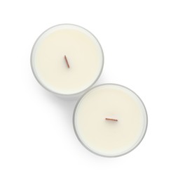 Photo of Aromatic soy candles with wooden wicks on white background, top view