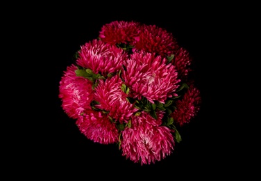 Photo of Bouquet of beautiful pink asters on black background, top view. Autumn flowers