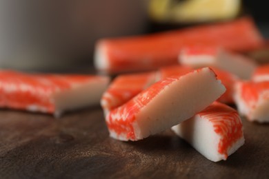 Fresh crab sticks on wooden cutting board, closeup